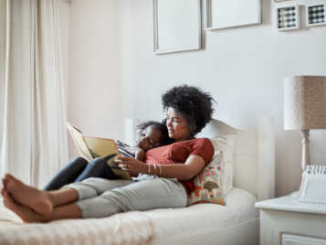 Mother reading a book to child