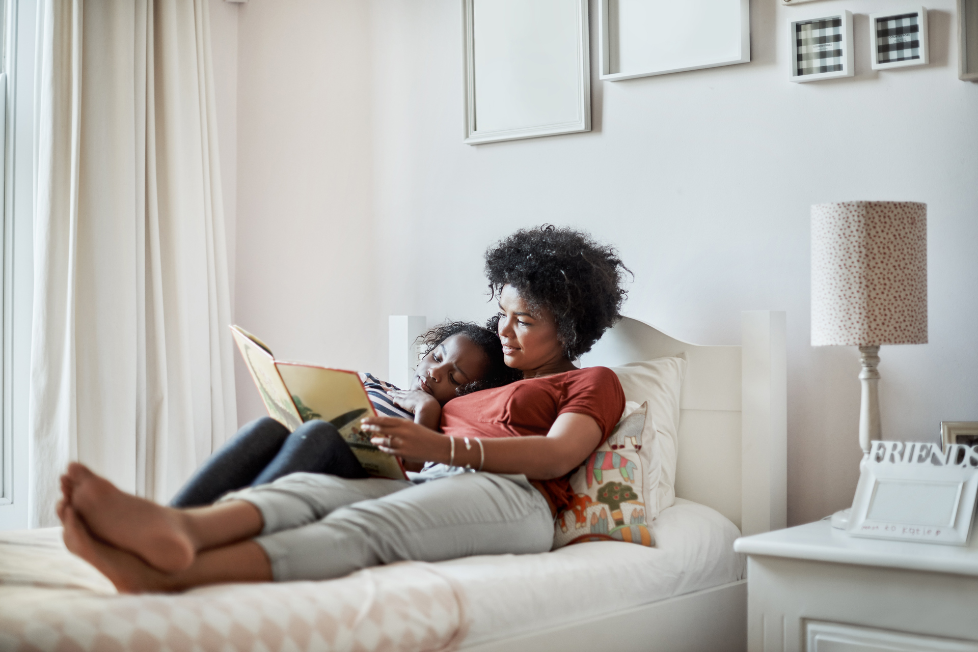 Mother reading a book to child