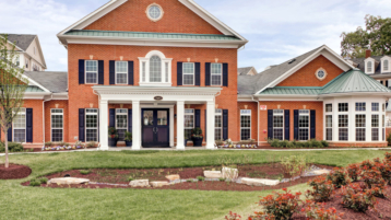 Brompton House brick front exterior with columns and landscaping
